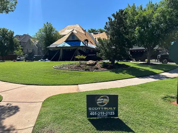 Roof replacement progress with ScottBuilt yard sign