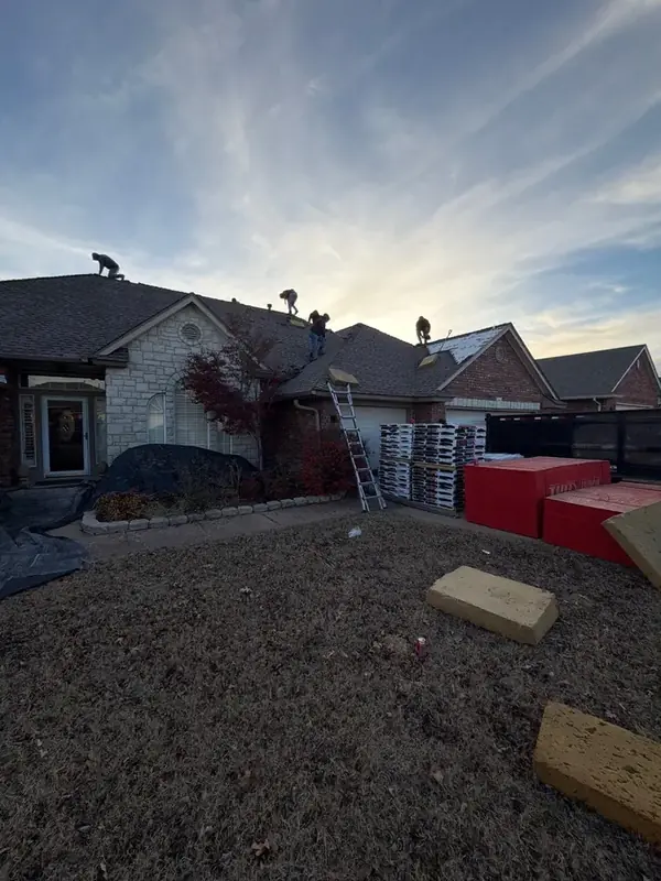 ScottBuilt roofing crew working at dusk