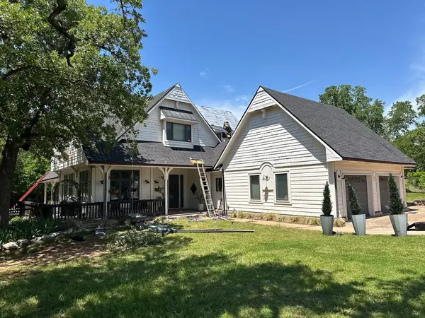 White farmhouse roof replacement by ScottBuilt